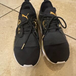 Puma Women’s Black and Gold Sneakers